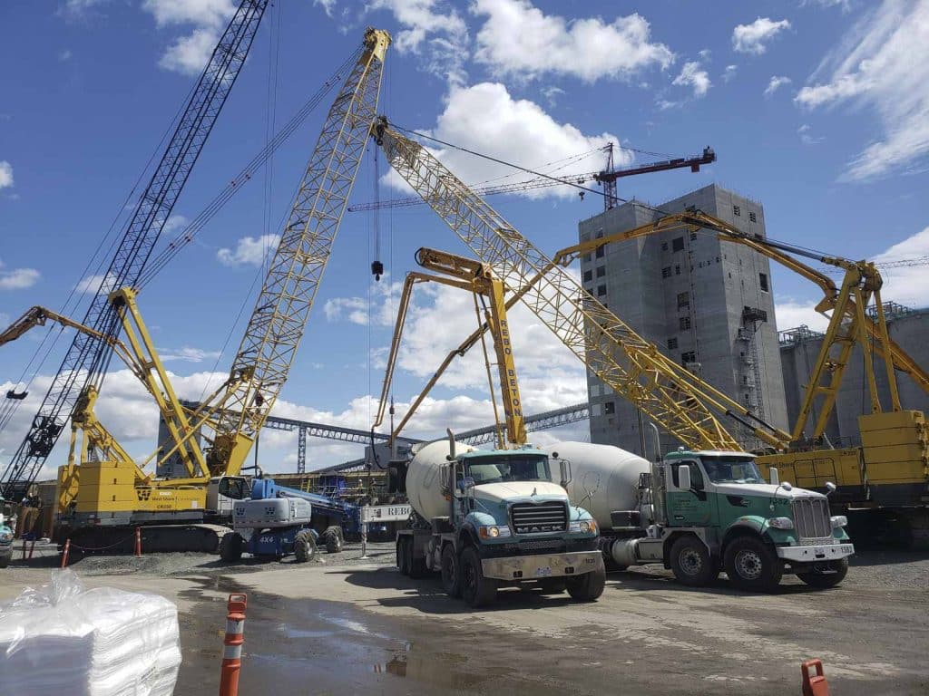 cranes-and-concrete-mixing-trucks-at-work-site